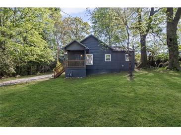 Charming single-story home with a well-manicured lawn and a cozy front porch surrounded by mature trees at 3406 Randell Brown Avenue Unit 3, Atlanta, GA 30354