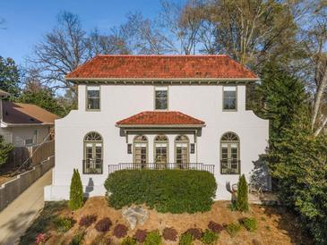 Stunning two-story home with a red tile roof and manicured front yard, offering timeless elegance and curb appeal at 1311 Berwick Ne Ave, Atlanta, GA 30306