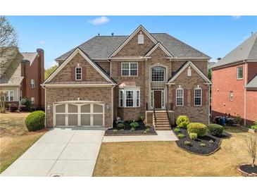 Beautiful brick home with manicured lawn and two-car garage offers classic suburban appeal and great curb appeal at 426 Vera Park Pl, Alpharetta, GA 30022