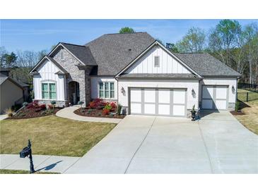 Beautiful single-Gathering home featuring a well-manicured lawn, stone accents, and a three-car garage at 432 Horizon Trl, Canton, GA 30114