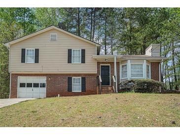 Charming two-story home with a combination brick and siding exterior and a well-maintained front yard at 1512 Daniel Ln, Lawrenceville, GA 30046