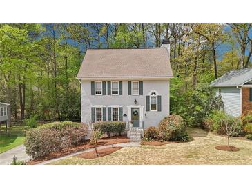 Charming two-story home with a well-manicured front yard and inviting entrance surrounded by mature trees at 4783 Deer Chase, Powder Springs, GA 30127