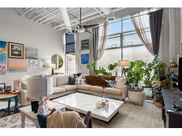 Bright living room featuring a large window, modern decor, stylish seating, and an open, airy atmosphere at 5200 Peachtree Rd # 2116, Atlanta, GA 30341