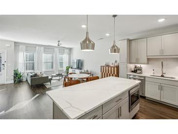 Bright, open-concept living room and kitchen area with modern finishes and stainless steel appliances at 2420 Lakeshore Se Ln, Atlanta, GA 30316