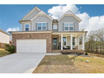 Charming two-story home featuring stone accents, inviting front porch, and a well-maintained front yard at 139 Rushing View Gln, Dallas, GA 30157