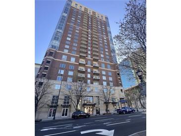 Museum Tower condo building with a mix of red brick and concrete, featuring balconies and a prominent entrance at 285 Centennial Olympic Park Dr # Ph 1-4, Atlanta, GA 30313