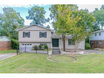 Charming two-story home with a well-manicured lawn and mature trees at 3891 Northstrand Dr, Decatur, GA 30035