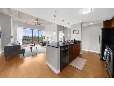 Bright, open living space featuring a modern kitchen, sleek furnishings, and large windows with a city view at 563 Memorial Se Dr # 504, Atlanta, GA 30312