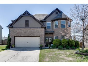 Charming two-story home with a well-manicured lawn, brick facade, and inviting double-door entryway at 4685 Orchard View Way, Cumming, GA 30028