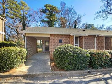 Charming brick townhouse with covered entryway and well-maintained landscaping at 3301 Henderson Mill Rd # 1, Atlanta, GA 30341