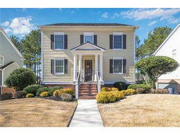 Charming two-story home with a manicured front yard and inviting entrance with brick steps at 6463 Century Park Se Pl, Mableton, GA 30126