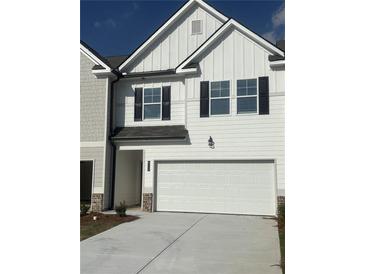 Charming exterior elevation featuring white siding, black shutters and a convenient two car garage at 6324 Rosetta Drive, Lot 2, South Fulton, GA 30331