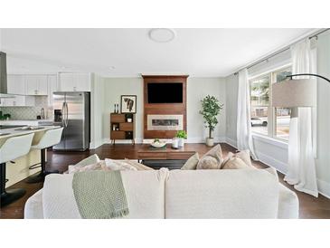 Bright living room featuring a fireplace, modern furniture, and plenty of natural light at 1276 Dahlgren Se Ln, Atlanta, GA 30316