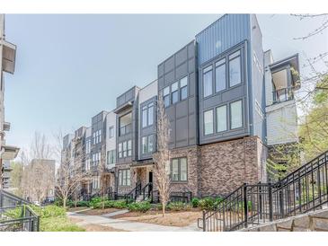 Modern townhome exterior featuring brick accents, large windows, and private balconies at 379 Pratt Se Dr # 408, Atlanta, GA 30315