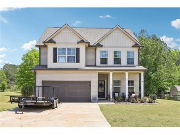 Beautiful two-story home featuring a spacious lawn, attached garage, and a charming front porch perfect for outdoor relaxation at 103 Cottage Way, Euharlee, GA 30145