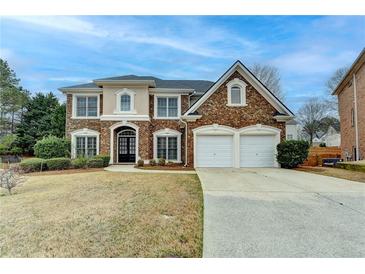 Charming two-story brick home with a well-manicured lawn and two-car garage at 2723 Ivy Bluff Ct, Buford, GA 30519