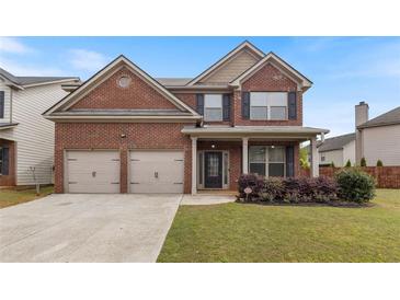 Beautiful two-story brick home featuring a two-car garage and well-maintained lawn at 461 Summerstone Ln, Lawrenceville, GA 30044