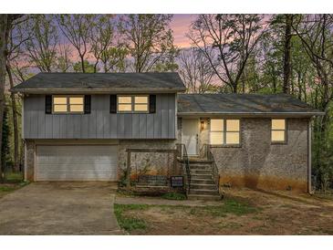 Charming split-level home with brick and siding, garage, and inviting front steps at 626 Mincey Ct, Stone Mountain, GA 30087