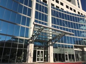 Modern building with glass facade and covered entrance, providing a sleek and professional appearance at 3324 Peachtree Ne Rd # 1010, Atlanta, GA 30326