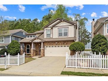 Charming two-story home with stone accents, attached two car garage and white picket fence at 3806 Carriage House Dr, Cumming, GA 30040