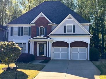 Two-story home with brick accents and a two-car garage and landscaped front yard at 1658 Lightfoot Cir, Marietta, GA 30062