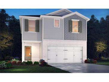 Charming two-story home featuring a brick and siding exterior, a two-car garage and manicured landscaping at 2771 Aralynn Way, College Park, GA 30337