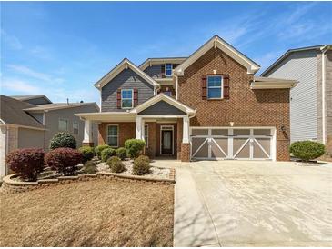 Charming two-story brick home with a well-maintained lawn and inviting front entrance at 2910 Blake Towers Ln, Buford, GA 30519
