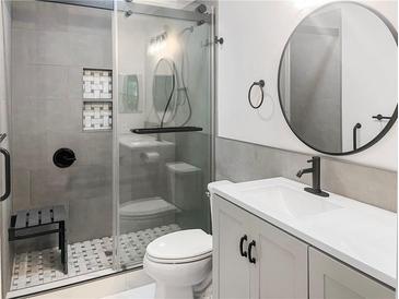 This modern bathroom features a glass shower door, black fixtures, and sleek vanity at 475 Mount Vernon Ne Hwy # 226C, Atlanta, GA 30328