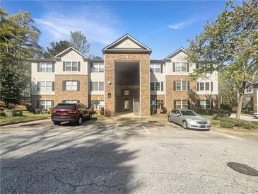 Attractive condo complex with a brick facade and well-maintained landscaping, ample parking, and easy access to amenities at 7302 Par Four Way, Lithonia, GA 30038