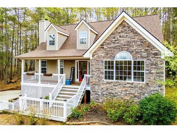 Charming home with stone and siding exterior, inviting front porch, and manicured landscaping at 9176 Lakeview Parkway, Villa Rica, GA 30180
