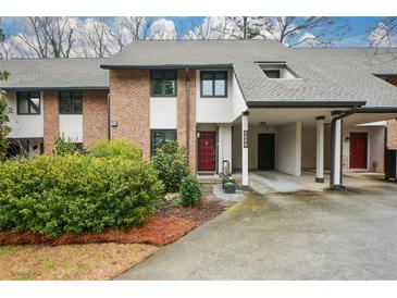 Charming townhome with brick facade, carport, and well-maintained landscaping at 3259 Clairmont North Ne, Brookhaven, GA 30329