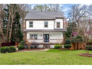 Charming two-story home with a well-manicured lawn and inviting front porch at 3991 Centennial Trl, Duluth, GA 30096