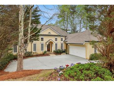 Charming two-story home featuring a spacious driveway and attached two-car garage at 535 Telford Pl, Atlanta, GA 30342