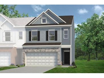 Charming two-story home with stone accents, gray siding, and a two-car garage at 1234 Ravencliff Dr # 157, Austell, GA 30168