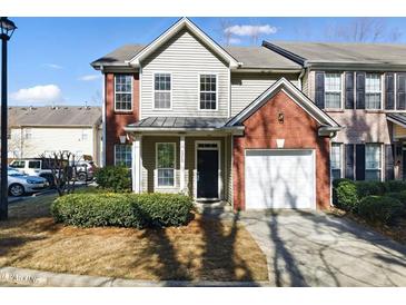 Charming two-story townhome with a well-maintained front yard and an attached one-car garage in a desirable neighborhood at 2572 Avery Park Cir, Doraville, GA 30360