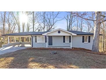 Charming single-story home with a covered carport and well-maintained front yard at 5496 Davis Dr, Austell, GA 30106