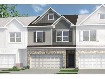 Charming townhome featuring a two-car garage, and attractive brick and siding exterior at 2540 Ravencliff Dr # 155, Austell, GA 30168