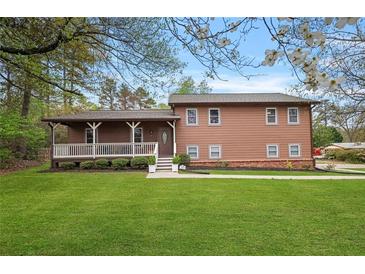 Charming two-story home with a welcoming front porch and well-manicured lawn, perfect for Gathering living at 3916 S Martin Way, Lithia Springs, GA 30122