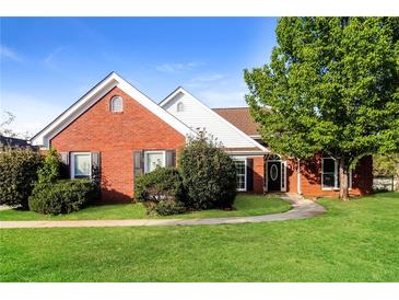 Charming brick home with a well-manicured lawn and mature trees at 4820 Camden Sw Dr, Conyers, GA 30094