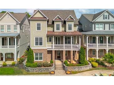 Charming two-story home featuring a brick and siding exterior, covered porch, and well-manicured landscaping at 1329 Booth Ave, Atlanta, GA 30318