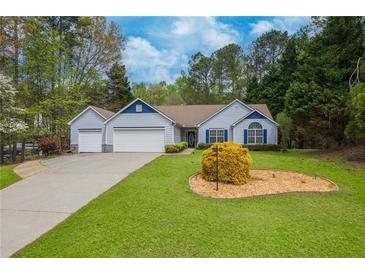 Charming one-story home with a well-manicured lawn and attached two car garage at 328 Allatoona Shores Dr, Canton, GA 30114