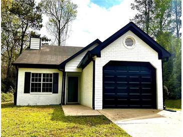 Charming single-story home with painted brick, black trim, and attached garage at 1864 Drew Cir, Austell, GA 30168