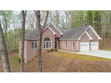 Charming brick home with attached two-car garage and mature trees at 240 Wrights Mill Way, Canton, GA 30115