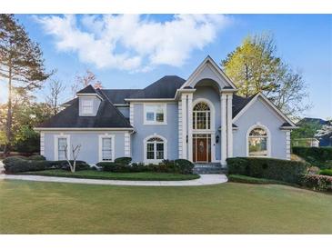 Charming two-story traditional home featuring a well-manicured front lawn and a symmetrical facade at 700 Henley Fields Cir, Johns Creek, GA 30097