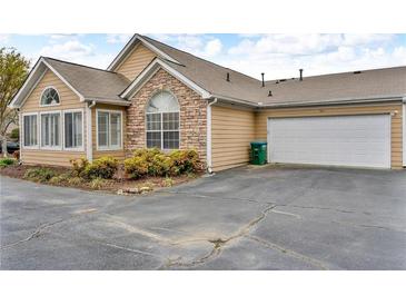 Tan home features an attached garage and stone accents on the facade at 2191 Rockbridge Rd # 501, Stone Mountain, GA 30087