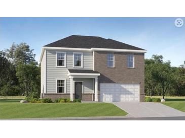 Charming two-story home featuring a combination of siding and brick, complemented by a well-manicured lawn at 232 Paisley Way, Locust Grove, GA 30248