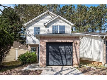 Charming home with a brick front and a one-car garage with ample parking on a tree lined street at 3651 Sapphire Ct, Decatur, GA 30034