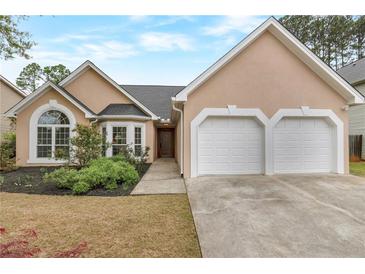 Charming single-story home with a well-manicured lawn and a two-car garage at 475 Brown Thrasher Ct, Alpharetta, GA 30009