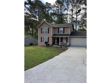 Charming two-story home with a well-manicured lawn and driveway at 230 Blue Heron Dr, Jonesboro, GA 30238