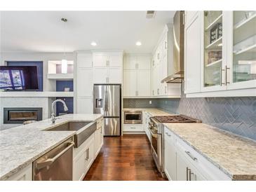 Bright kitchen boasts stainless steel appliances, a large island, and a modern design with custom backsplash at 828 Canterbury Overlook Ne, Atlanta, GA 30324